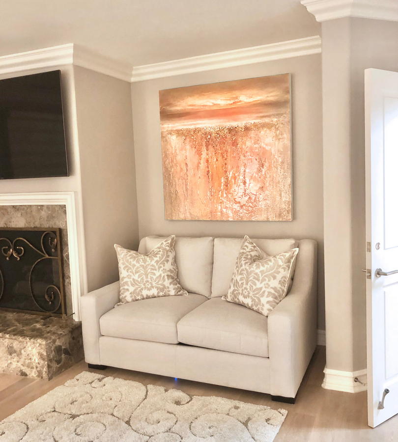 Peach colored original mixed media abstract coastal artwork by California artist Dasha Guilliam hanging on a bedroom wall over a love seat in a modern California beach house bedroom.